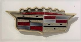 1957 Cadillac Hood Emblem Crest + Bezel NOS  Free Shipping In The USA